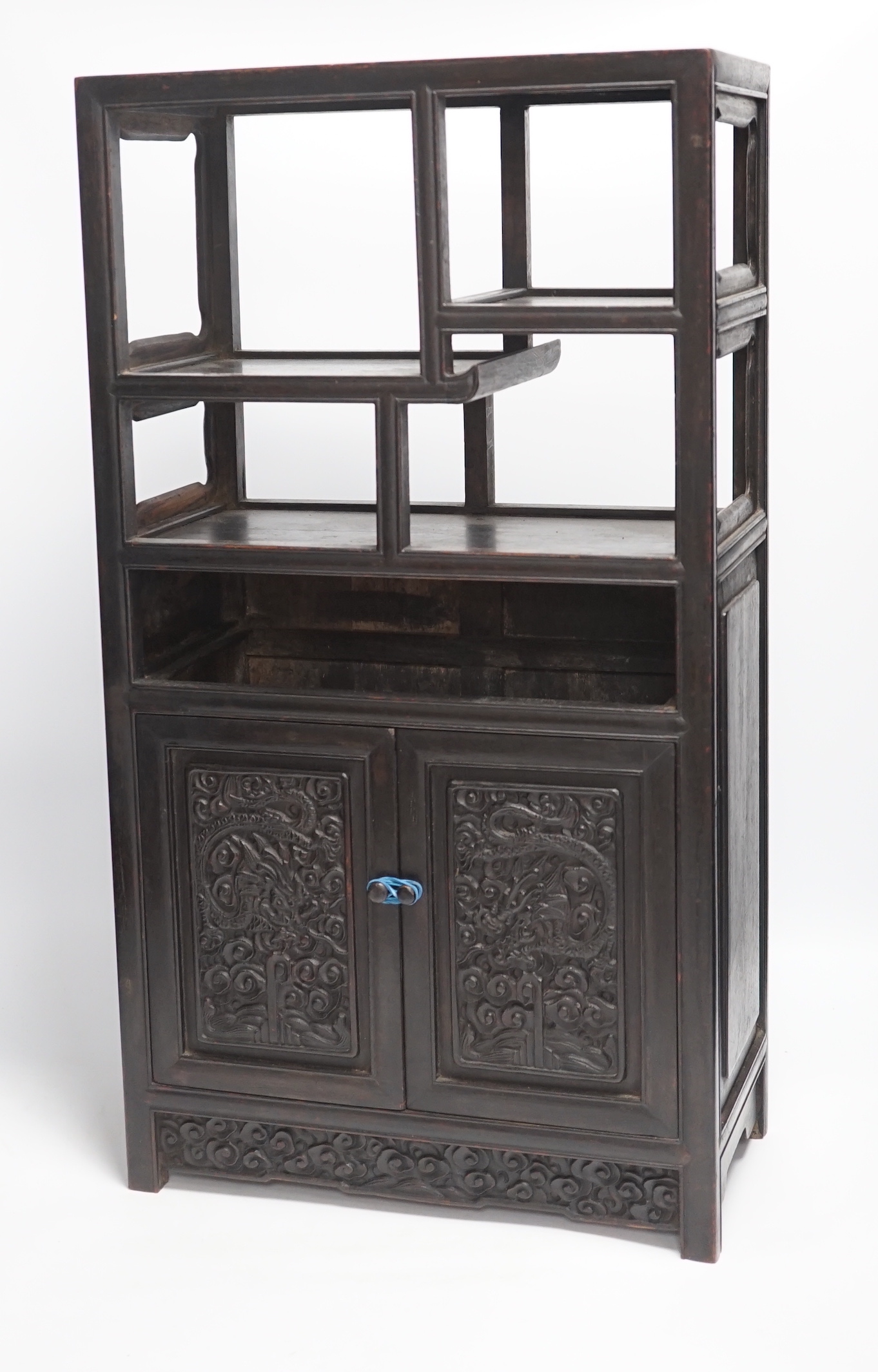 An early 20th century Chinese hongmu cabinet with carved cupboard doors, 61cm high